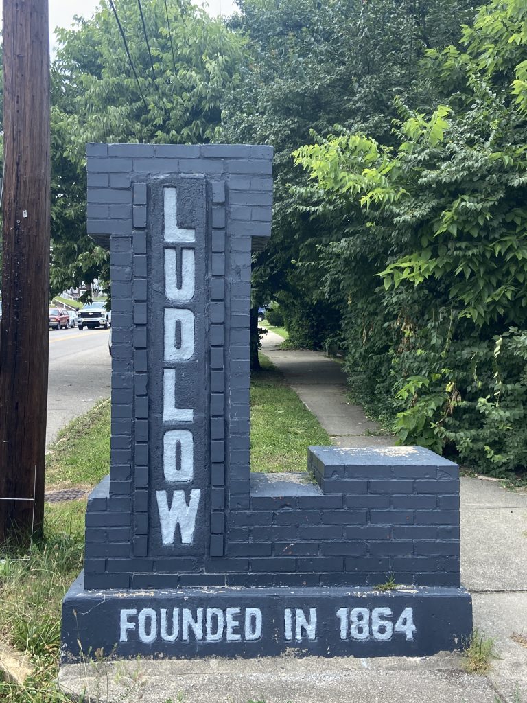 Ludlow KY brick welcome sign in the shape of the letter "L"